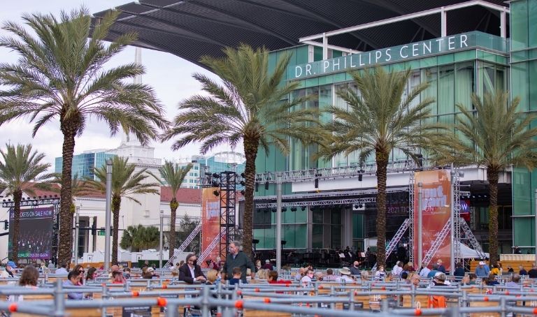 Photo of the Dr. Phillips Center Frontyard Festival™ in January 2021, taken from right side of audience. Orlando Philharmonic Orchestra onstage in background.