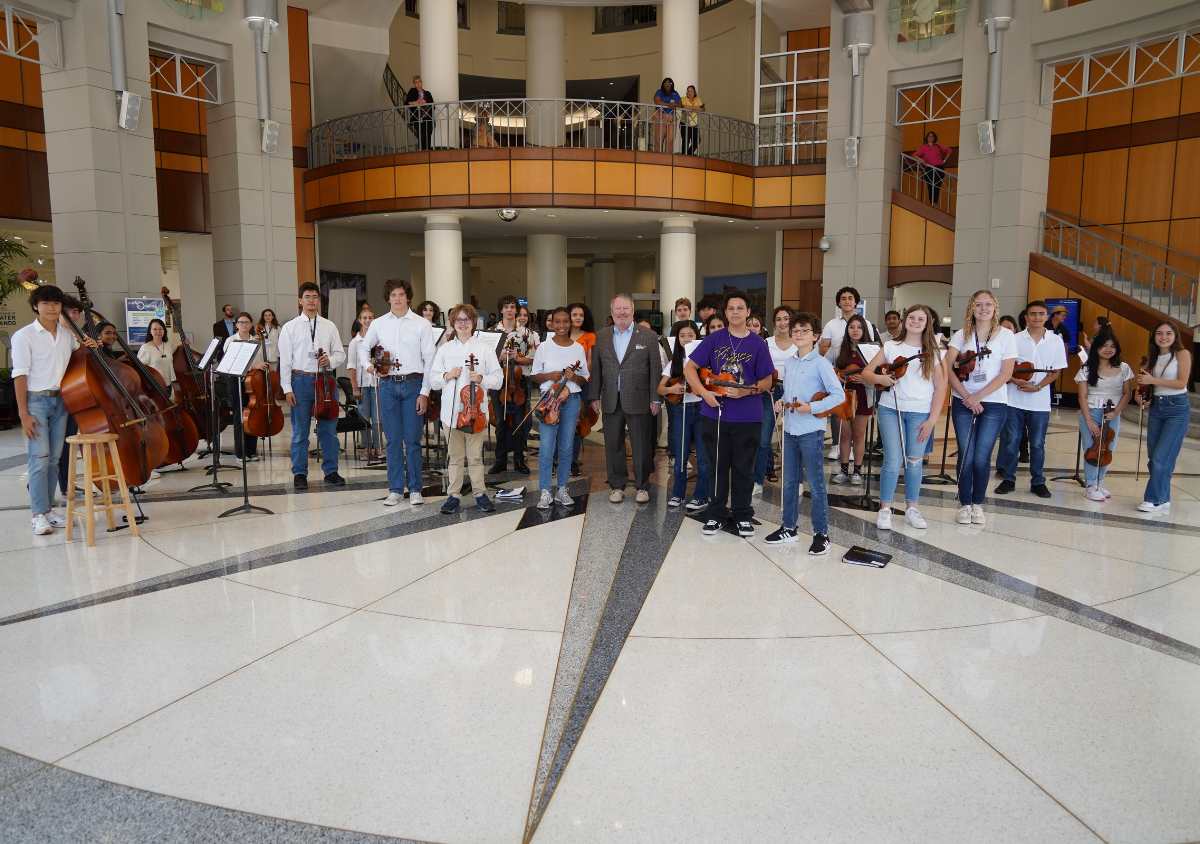 A photo of OPO Summer Camp students with City of Orlando Mayor Buddy Dyer at a City Hall performance on June 7, 2023.